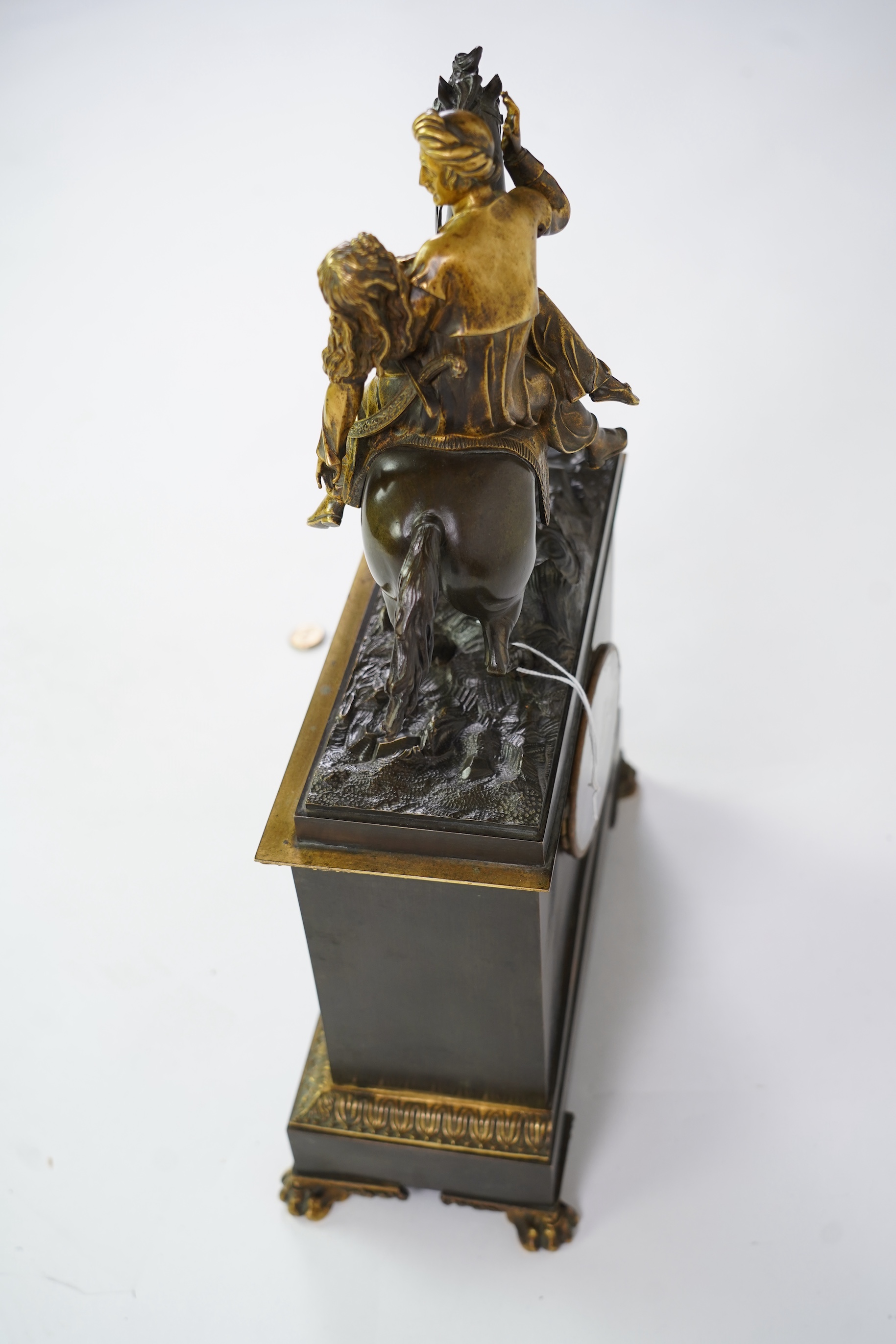 A late nineteenth century brass and bronze cased clock, mounted with a part gilt bronze of a mounted Turkish soldier and woman